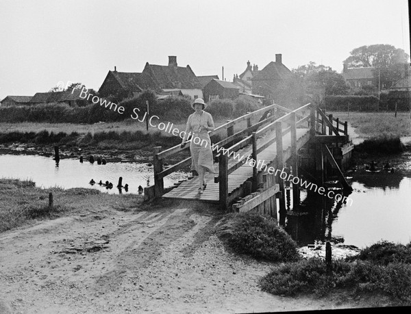 CHURCH WITH LADY ON FOOTBRIDGE